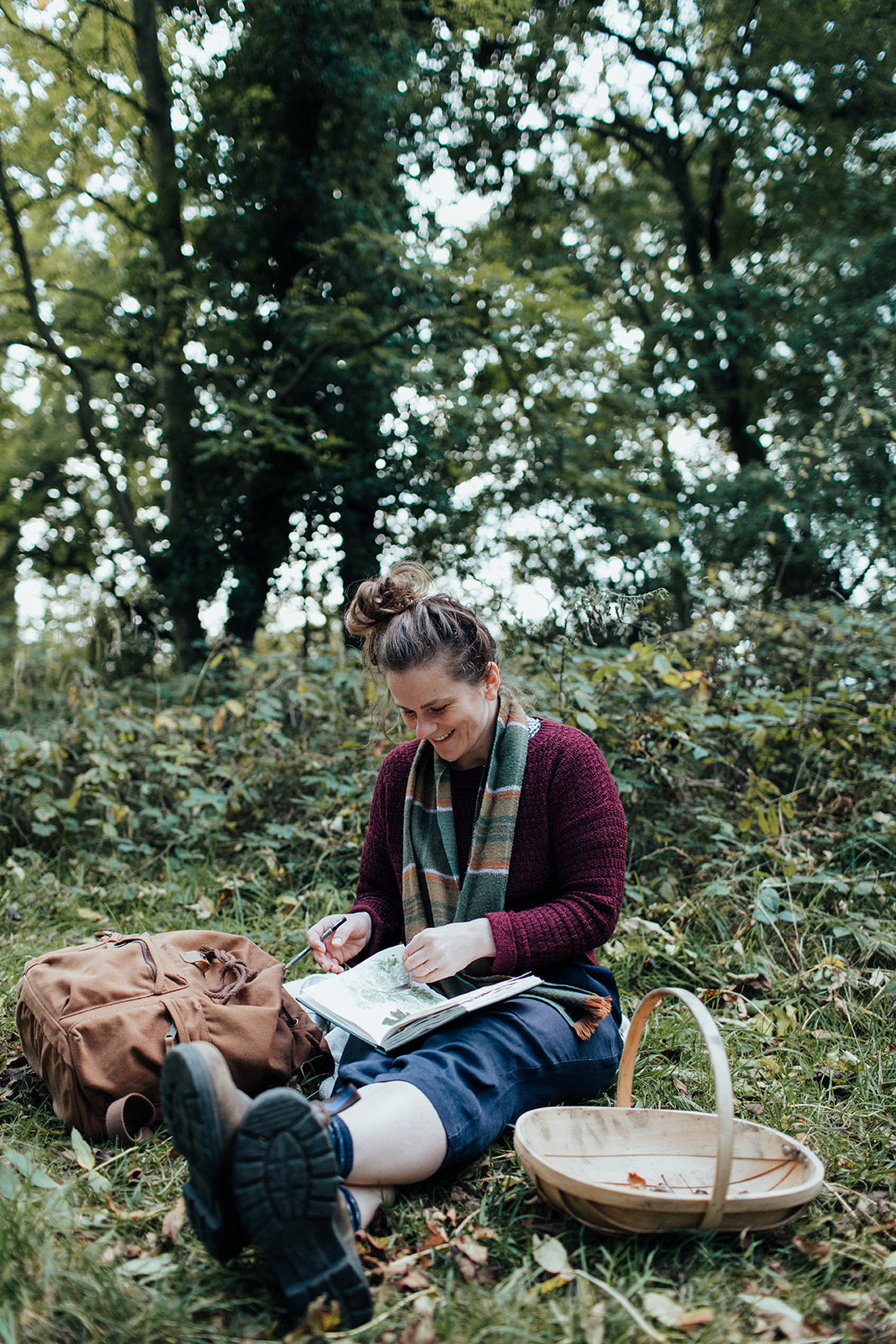 Agnes Becker of We Are Stardust nature journalling in a forest